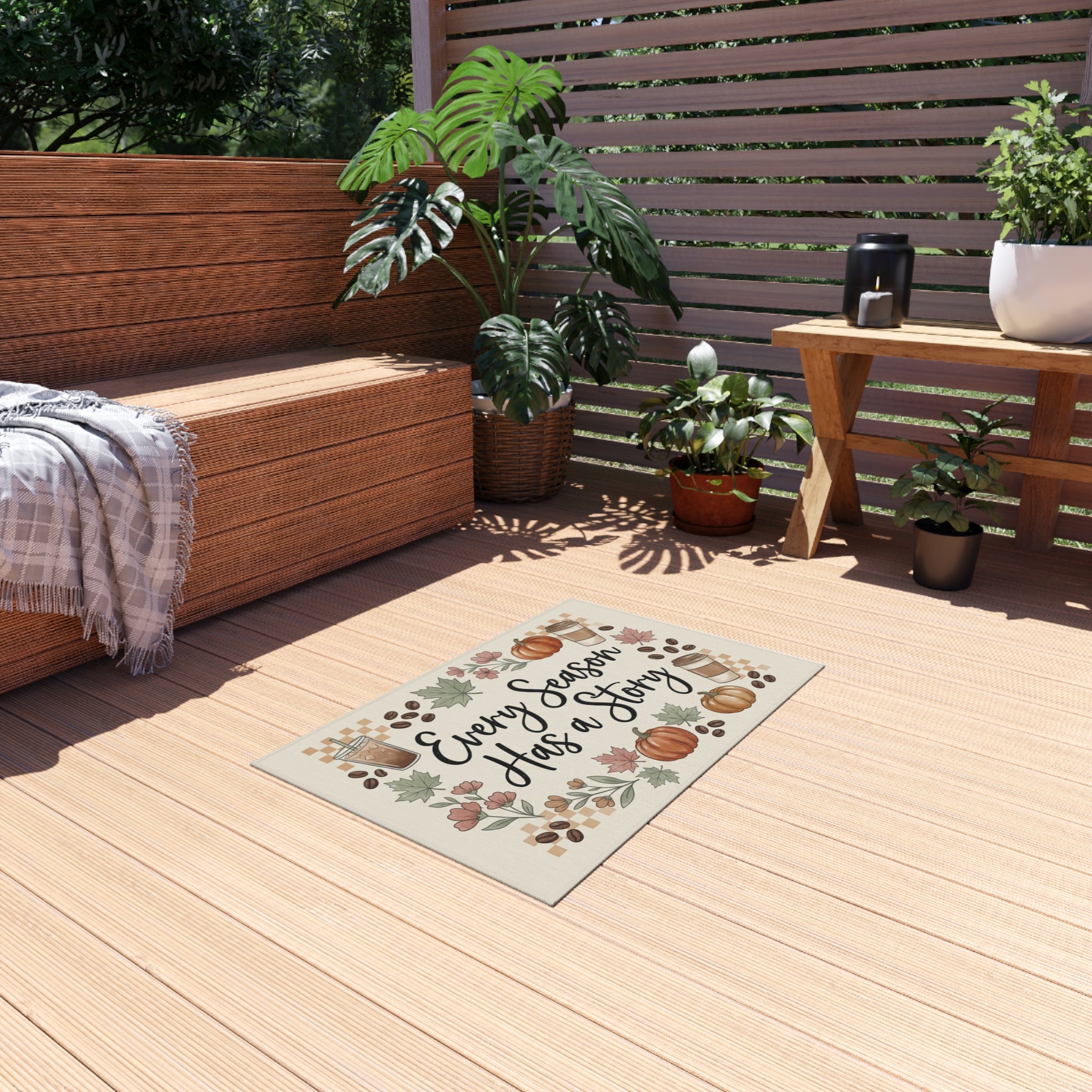 Every Season Has a Story Outdoor Rug with pumpkins, leaves, and coffee cups on a wooden deck.