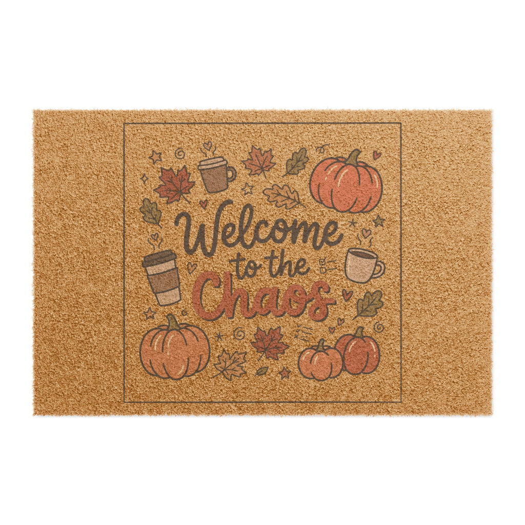 Front view of a coir doormat with "Welcome to the Chaos" text, surrounded by pumpkins, coffee mugs, and autumn leaves.