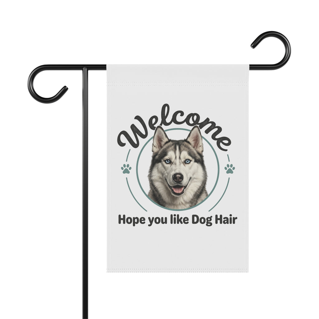 White garden flag with a husky dog face, "Welcome" and "Hope you like Dog Hair" text, on a black stand.