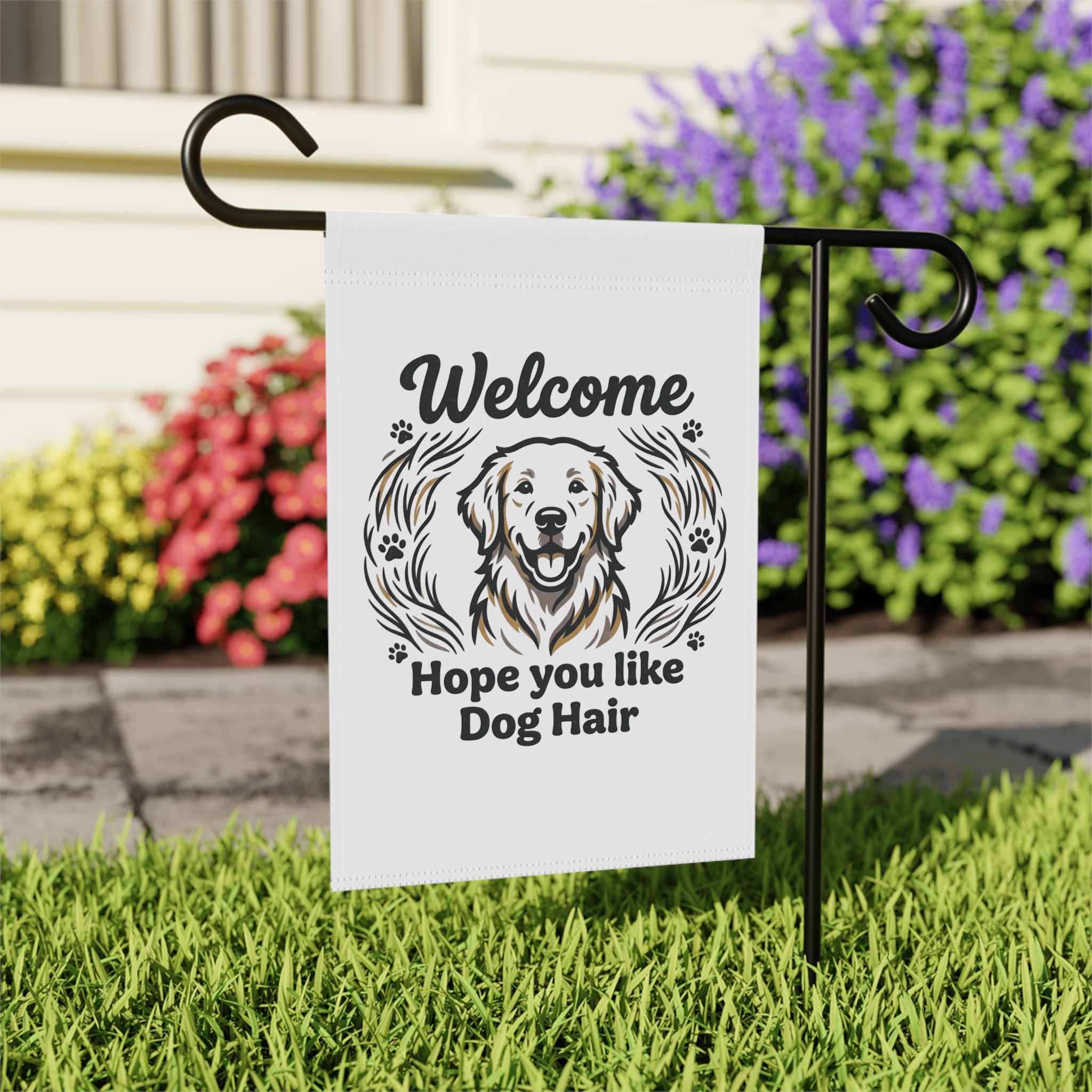 Garden Flag with a Golden Retriever and text "Welcome Hope you like Dog Hair" on a black stand in a garden.