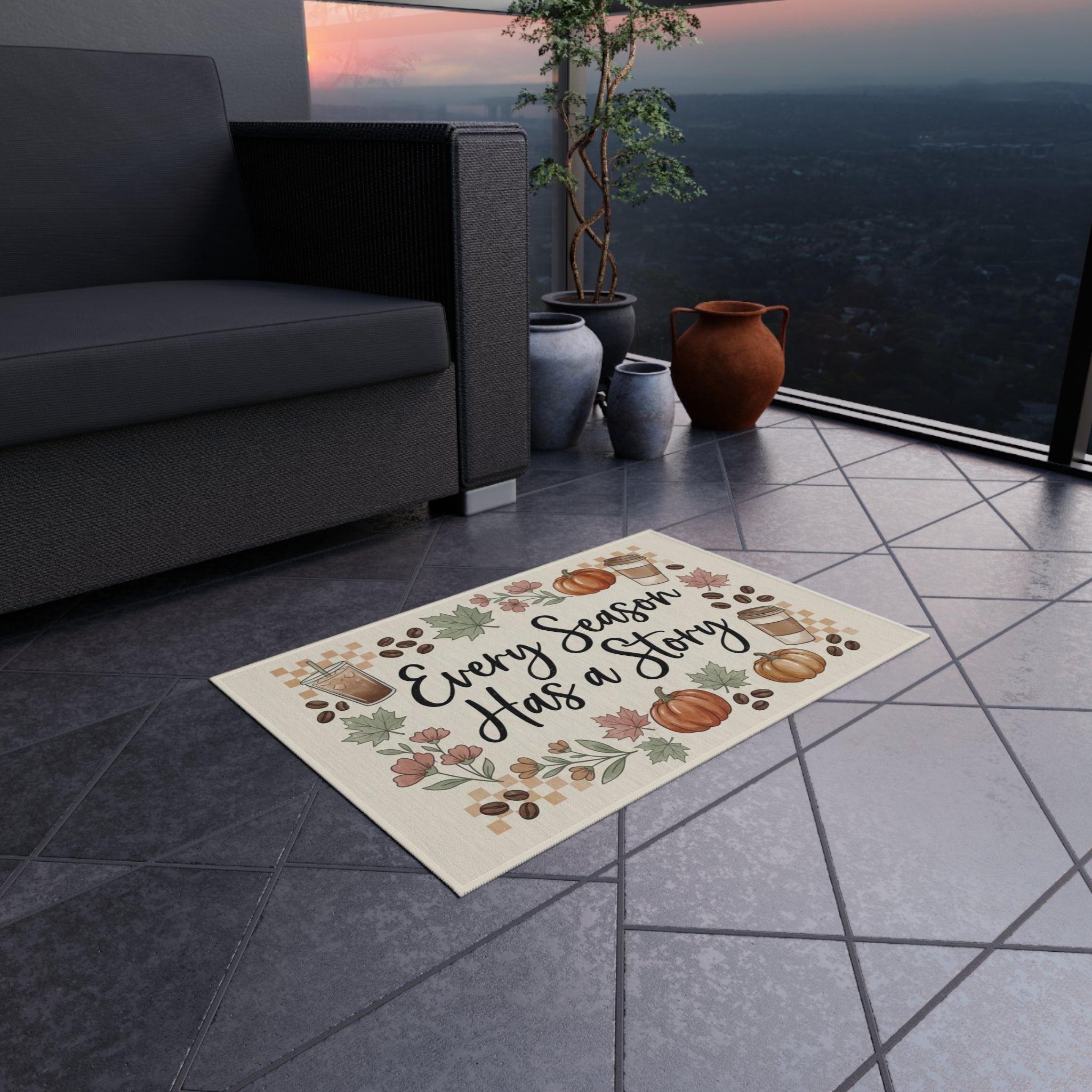 Every Season Has a Story Outdoor Rug, a fall doormat with pumpkins, leaves, and coffee cups, on a patio.