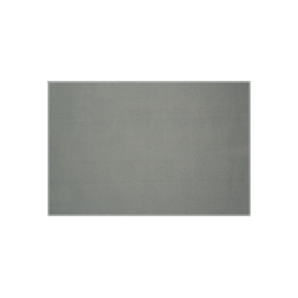 A rectangular outdoor rug with a gray, tightly woven texture, seen from a top-down angle.