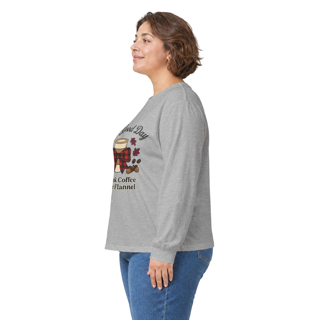 Side view of a woman wearing a gray long sleeve tee with "It's a Good Day to Drink Coffee & Wear Flannel" graphic.