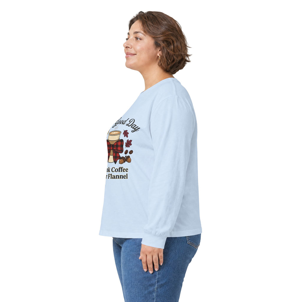 Side view of a woman wearing a light blue long sleeve tee with "It's a Good Day to Drink Coffee & Wear Flannel" graphic.