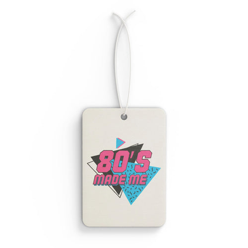Front view of the "80's Made Me" car air freshener, featuring a retro neon pink and teal graphic.