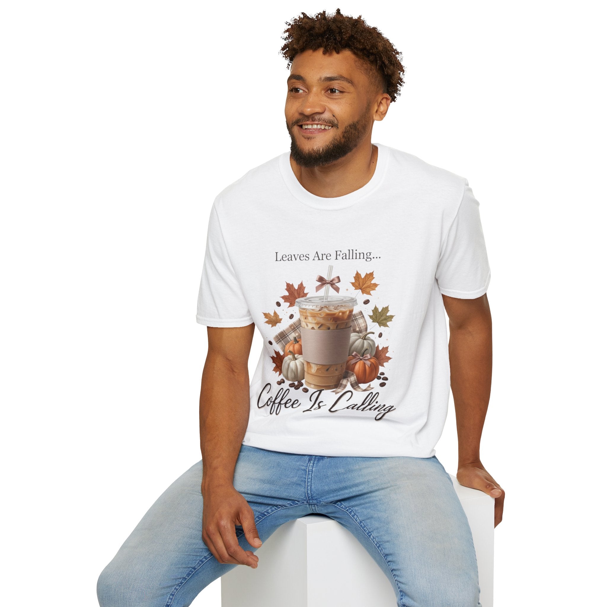 Man wearing a white "Leaves Are Falling... Coffee Is Calling" t-shirt with an iced latte, pumpkins, and fall leaves graphic.