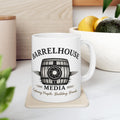 Front view of a white ceramic Barrelhouse Media Logo Coffee Mug with a barrel and camera lens graphic.